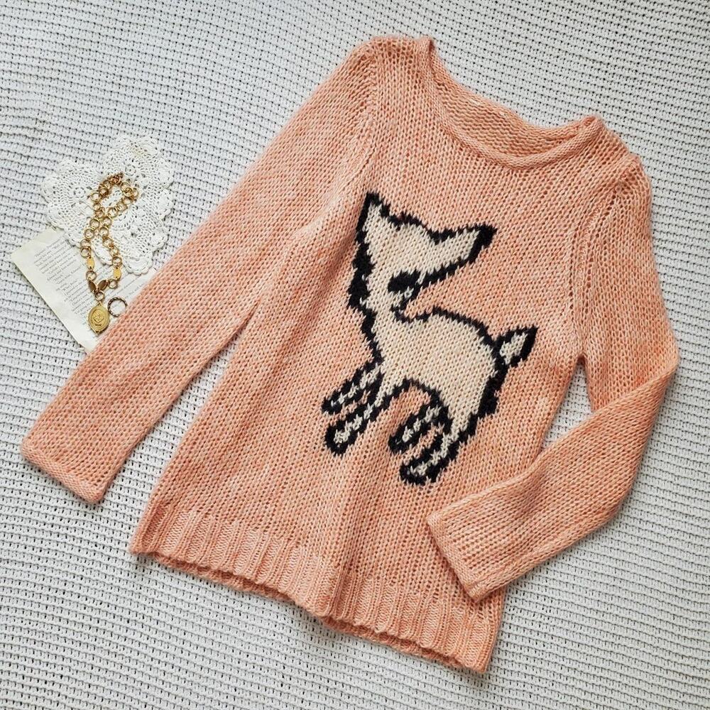 Pink knit long sleeve sweater with a fawn on the front